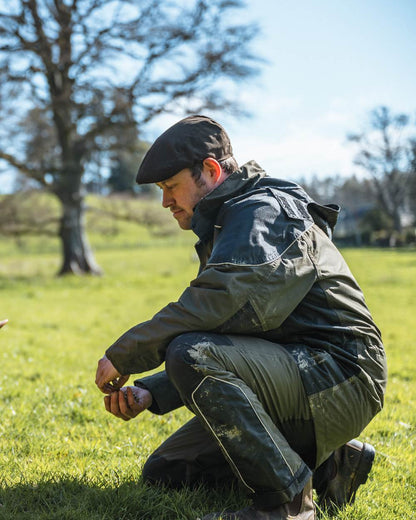 Green Coloured Hoggs of Fife Field Tech Waterproof Jacket on forest background 