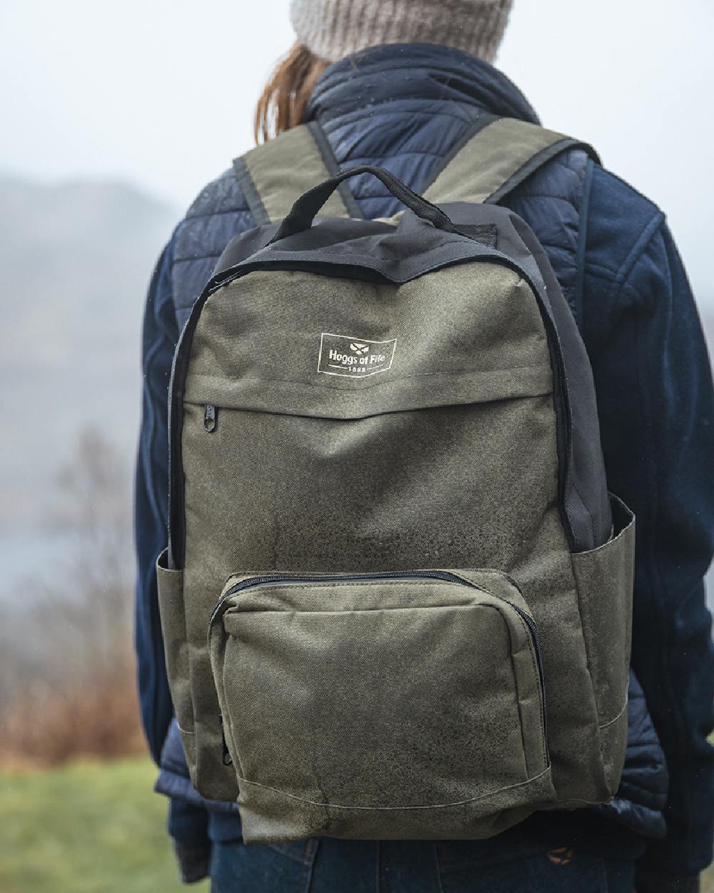 Green Black Coloured Hoggs of Fife Field &amp; Trek Backpack on blurry background 