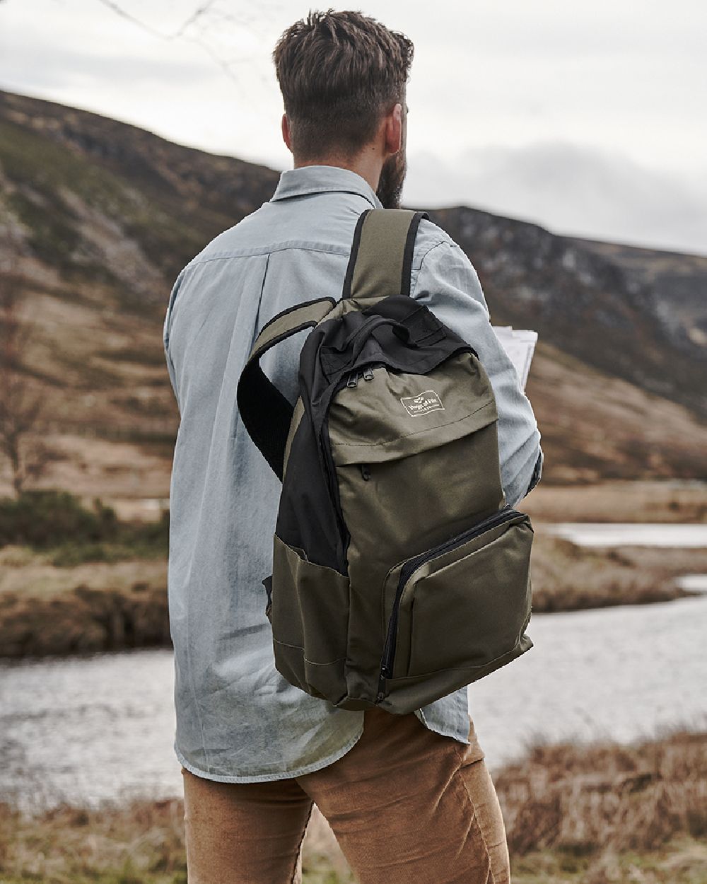 Green Black Coloured Hoggs of Fife Field &amp; Trek Backpack on mountain background 