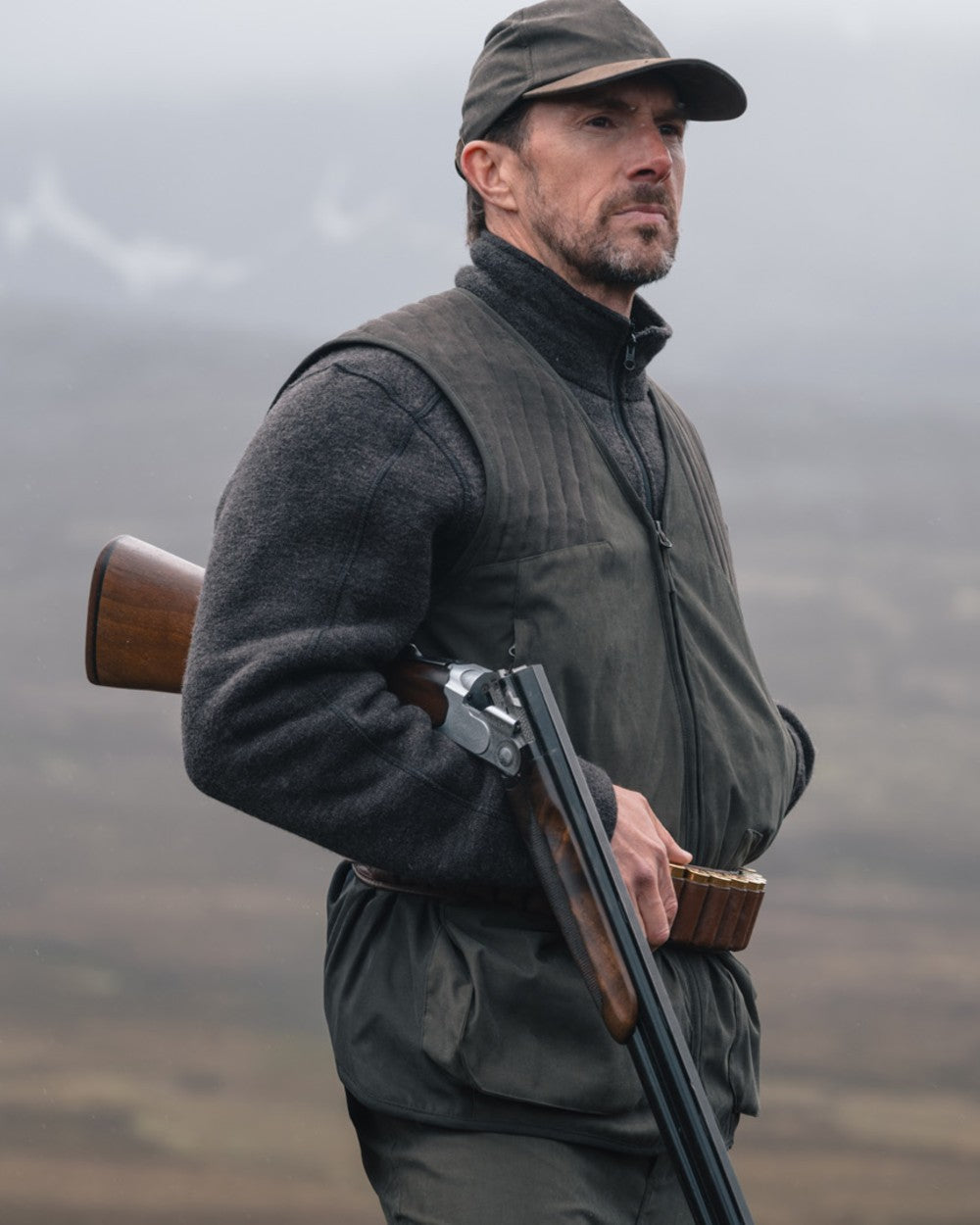 Bracken coloured Hoggs of Fife Mens Gairloch Knitted Fleece Lined Jacket on misty moorland background 