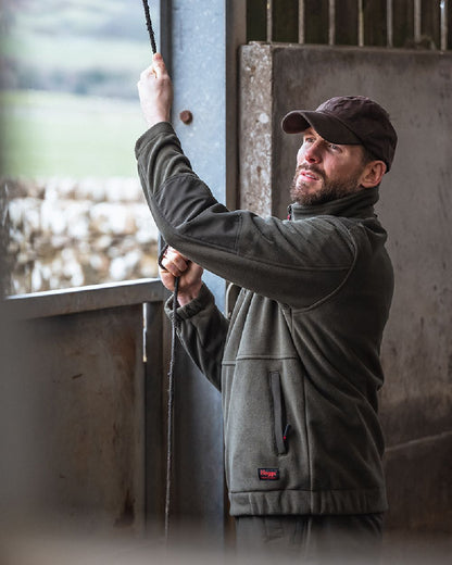 Green Coloured Hoggs of Fife Green King II 1/4 Zip Bonded Fleece on window background 