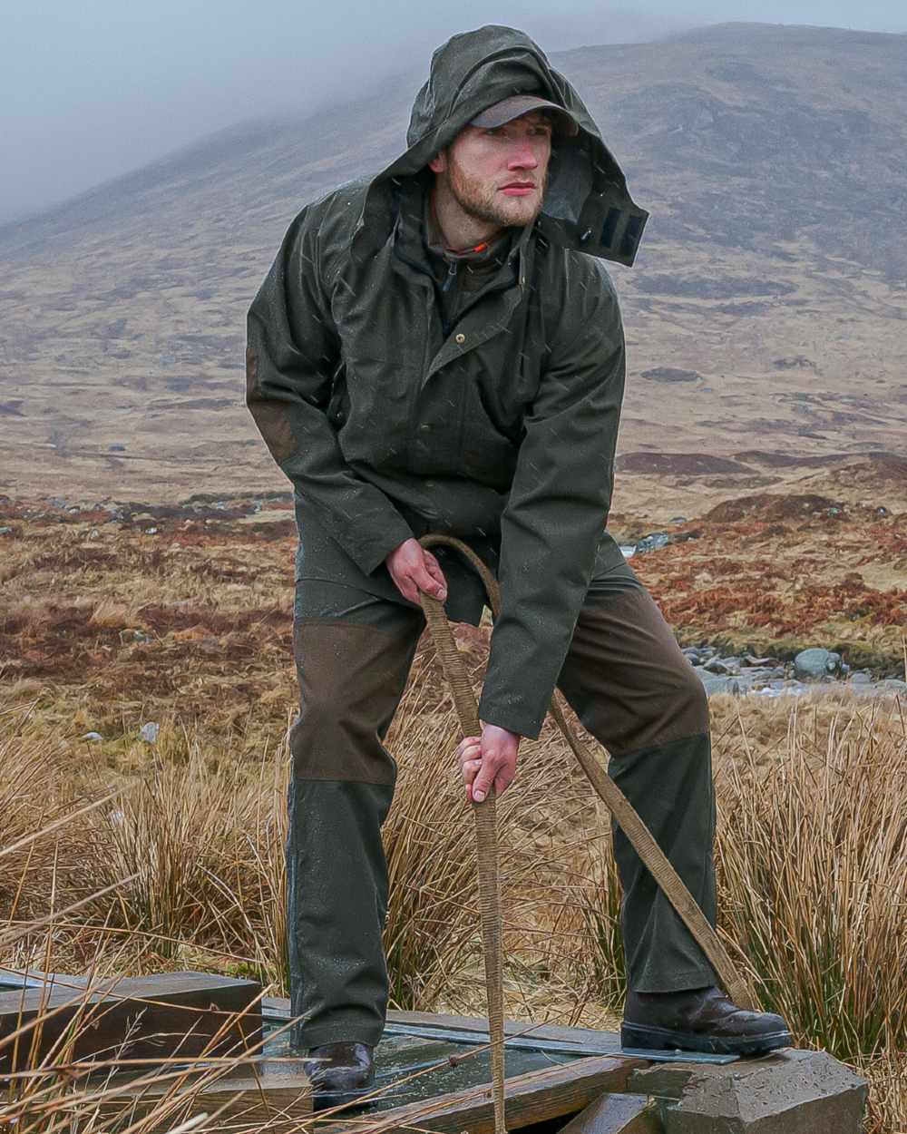 Green Coloured Hoggs of Fife Green King II Waterproof Jacket on mountain background 
