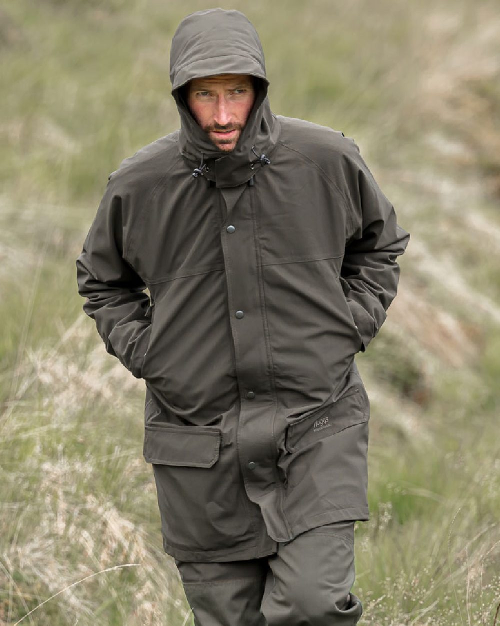 Green Coloured Hoggs of Fife Green King II Waterproof Jacket on grass background 