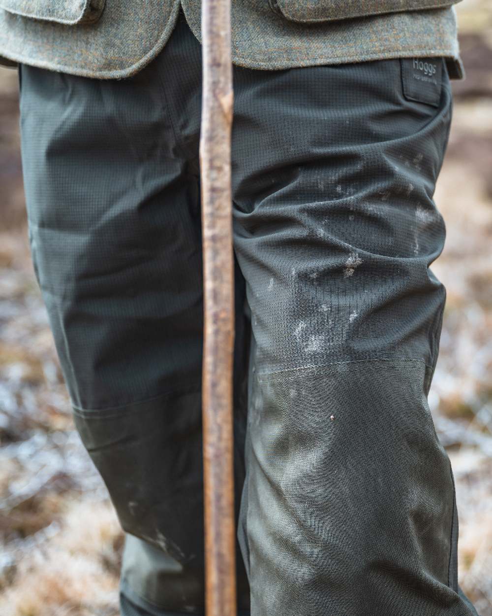 Green Coloured Hoggs of Fife Green King II Waterproof Trousers on blurry background 