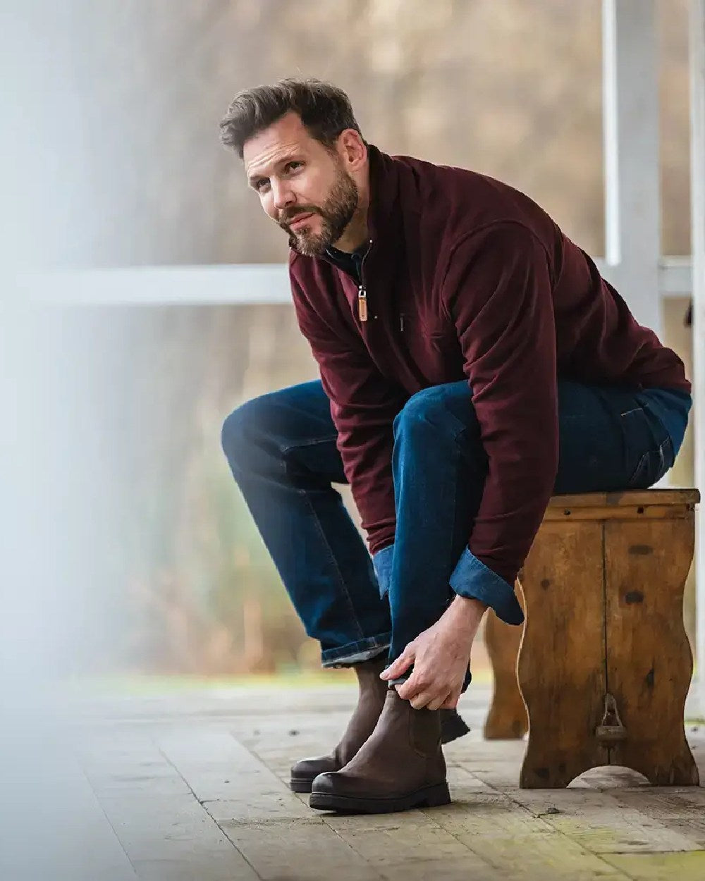 Burgundy coloured Hoggs of Fife Islander 1/4 Zip Micro Fleece Shirt on blurry background 