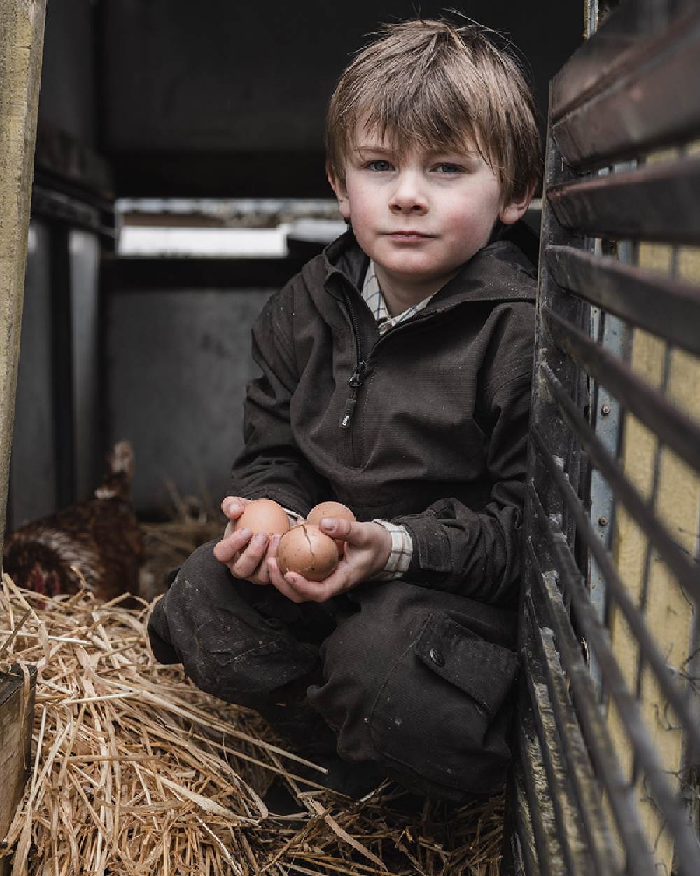 Dark Green Coloured Hoggs of Fife Junior Struther Waterproof Smock on hutch background 