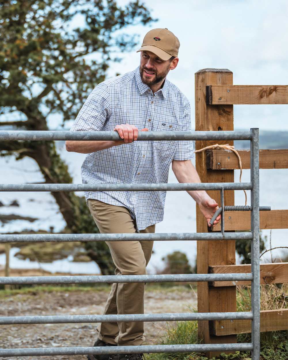 Brown/Blue Coloured Hoggs of Fife Kessock Tattersall Short Sleeved Shirt On A barn Background 