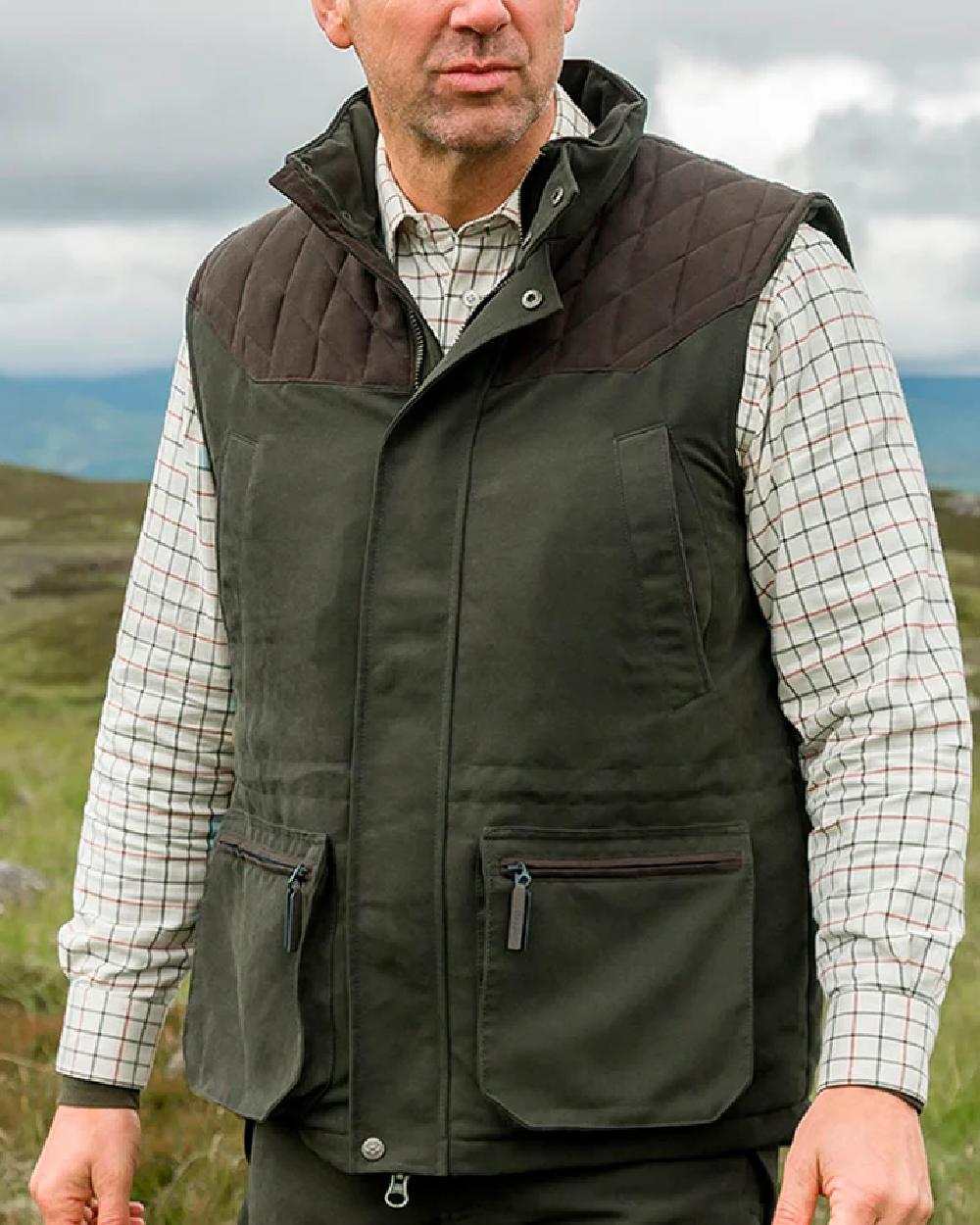 Olive Green Coloured Hoggs of Fife Kincraig Field Waistcoat on sky background 