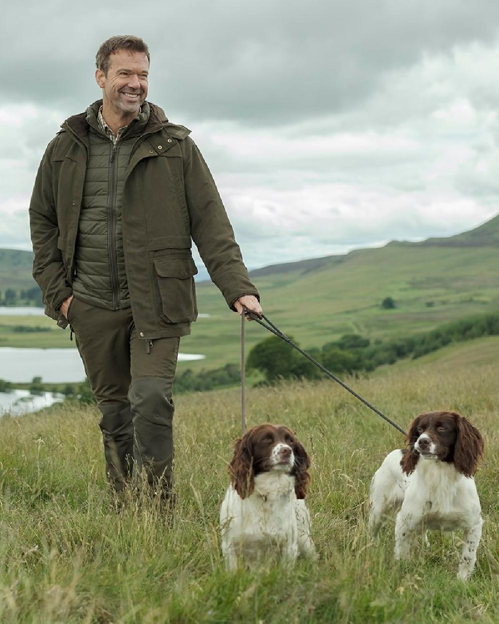 Olive Green Coloured Hoggs of Fife Kincraig Waterproof Field Trousers on countryside background 