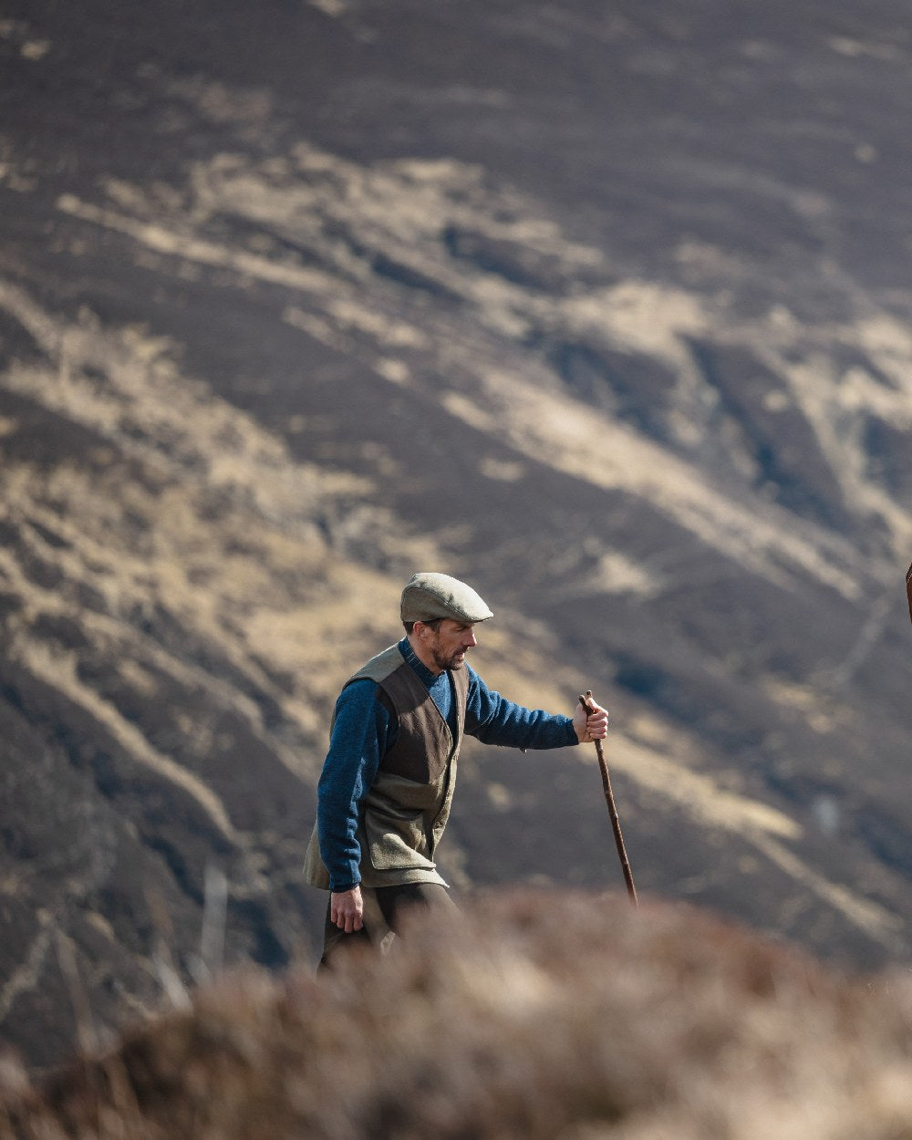 Autumn Bracken Coloured Hoggs of Fife Kinloch Technical Tweed Field Waistcoat on mountain background 