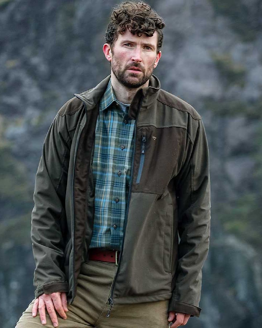 Green Brown Coloured Hoggs of Fife Kinross II Waterproof Field Jacket on blurry background 