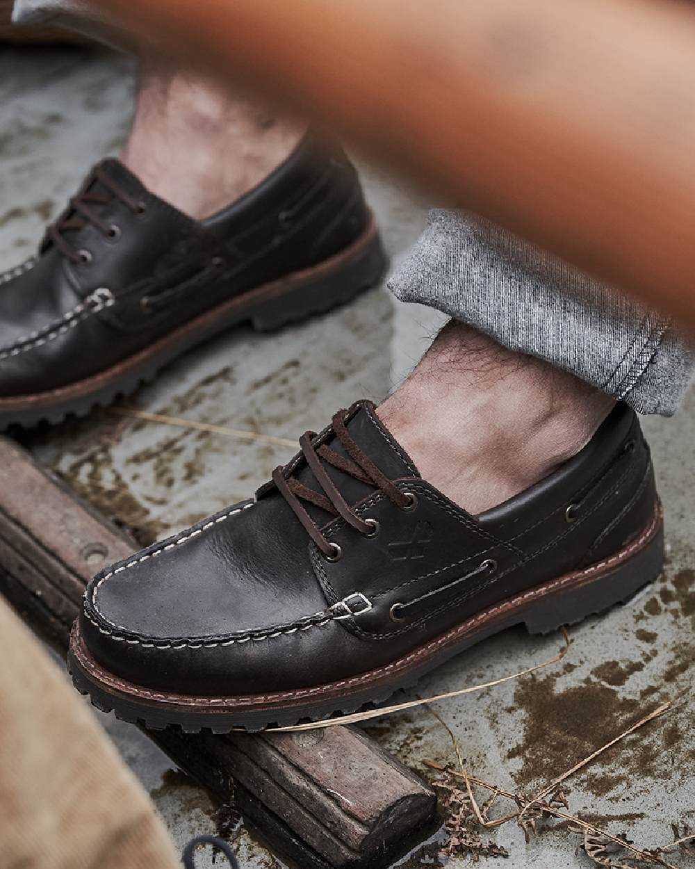 Chestnut Coloured Hoggs of Fife Kintyre Rugged Moccasin Boat Shoes on land background 