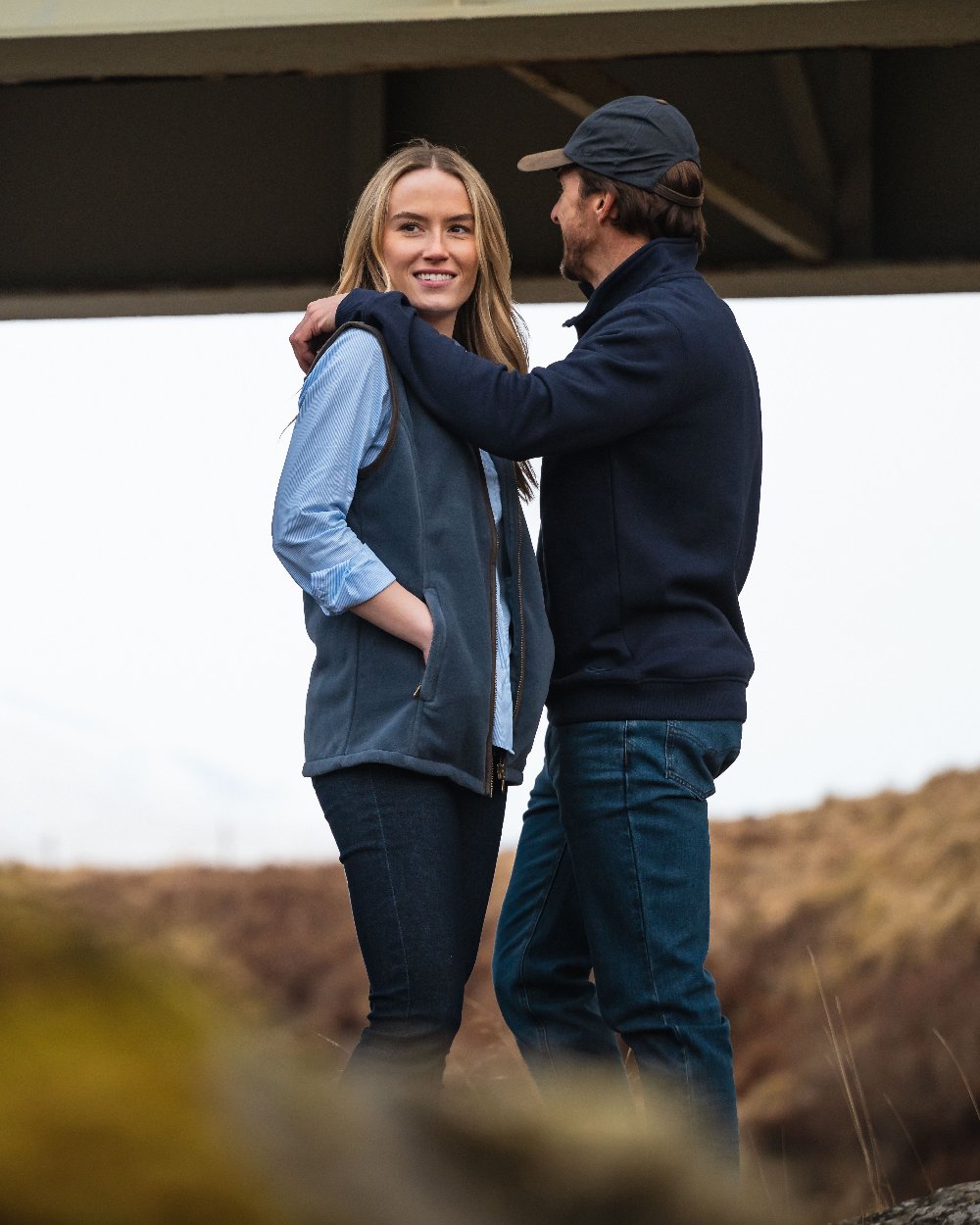 Navy Coloured Hoggs of Fife Leather Peak Waxed Baseball Cap on blurry background 