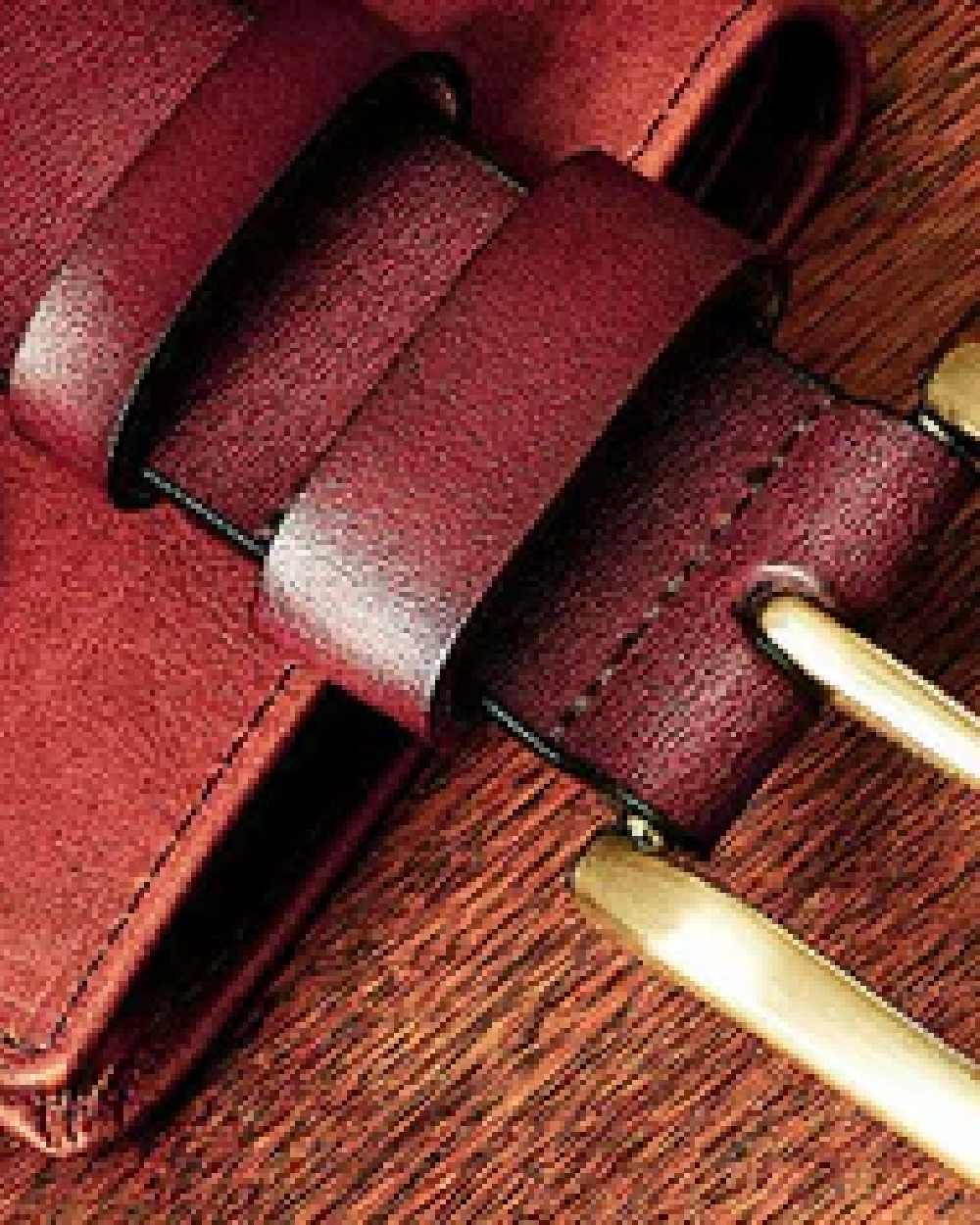 Tan Coloured Hoggs of Fife Luxury Leather Belts on wood background 