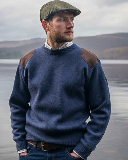 Storm Blue coloured Hoggs of Fife Melrose II Crew Pullover on sea background 