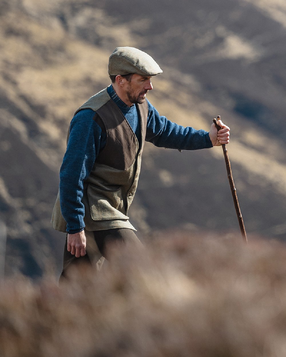 Storm Blue coloured Hoggs of Fife Melrose II Crew Pullover on blurry background 