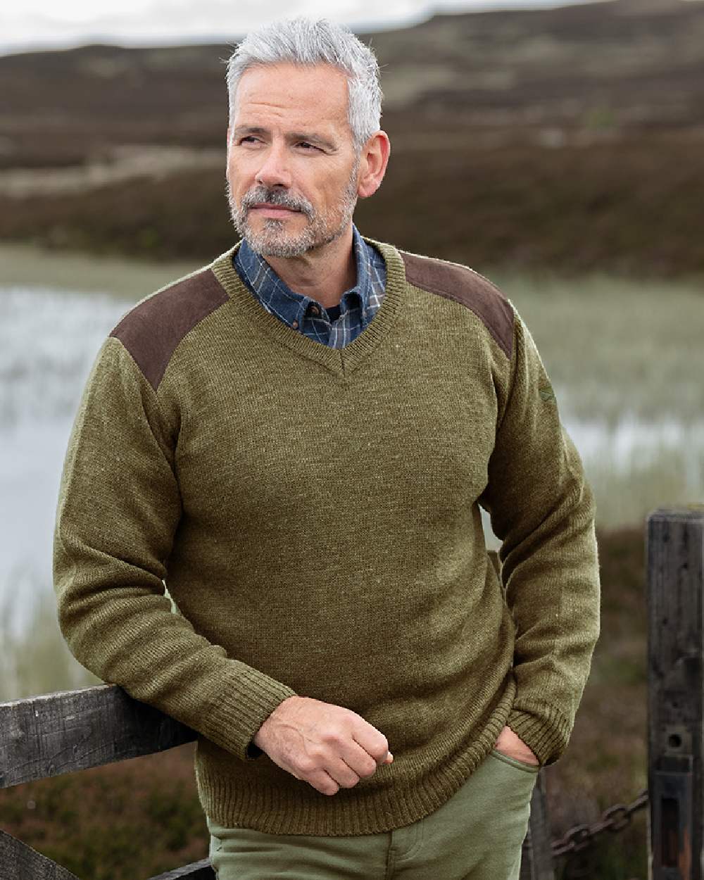 Meadow Green coloured Hoggs of Fife Melrose II V Neck Pullover on pond background 