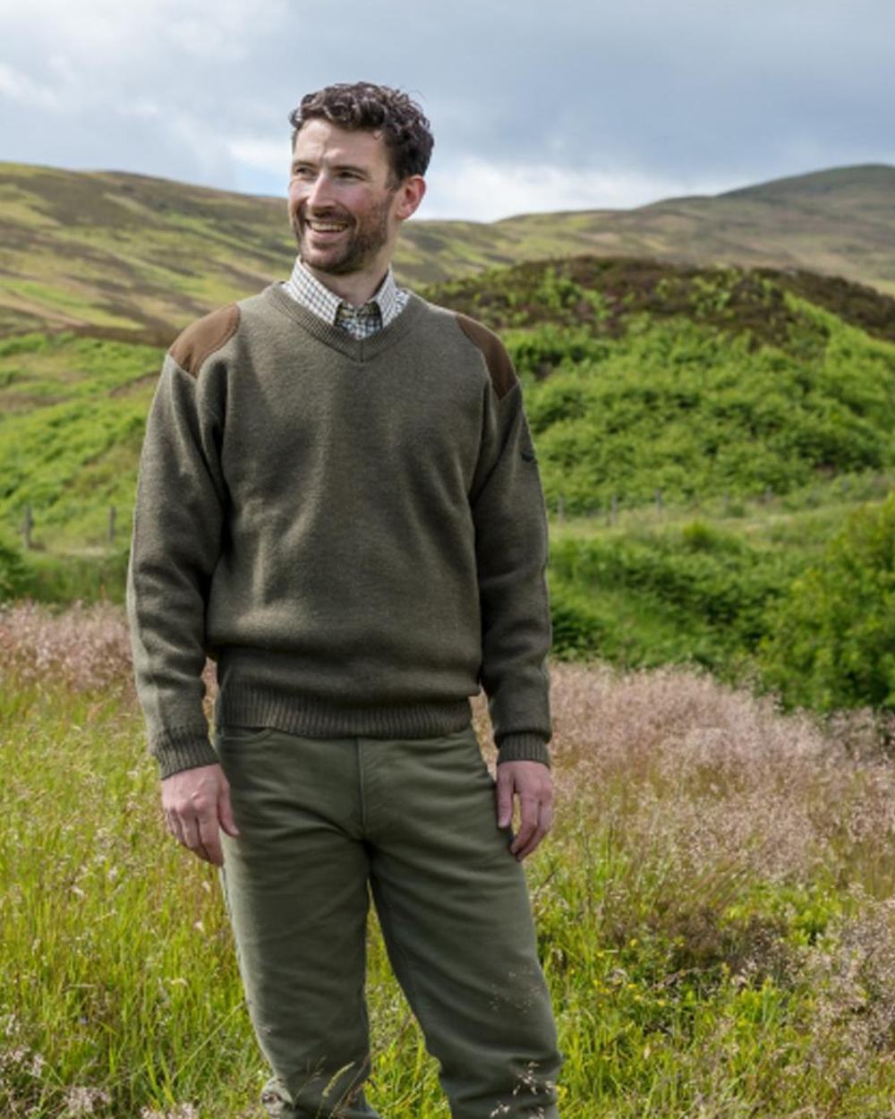 Meadow Green coloured Hoggs of Fife Melrose II V Neck Pullover on mountain background 