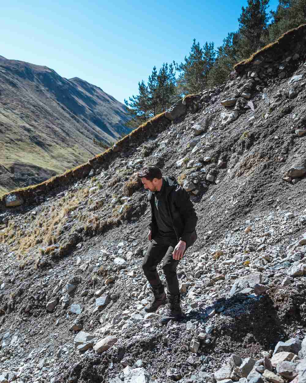 Green Coloured Hoggs of Fife Mens Ardross 4 Way Active Jacket on mountain background 