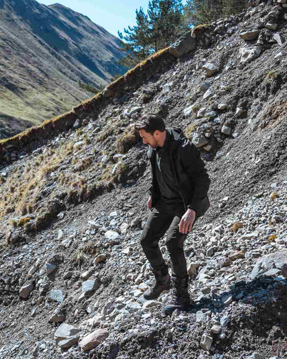 Green Coloured Hoggs of Fife Mens Ardross 4 Way Active Trousers on mountain background 