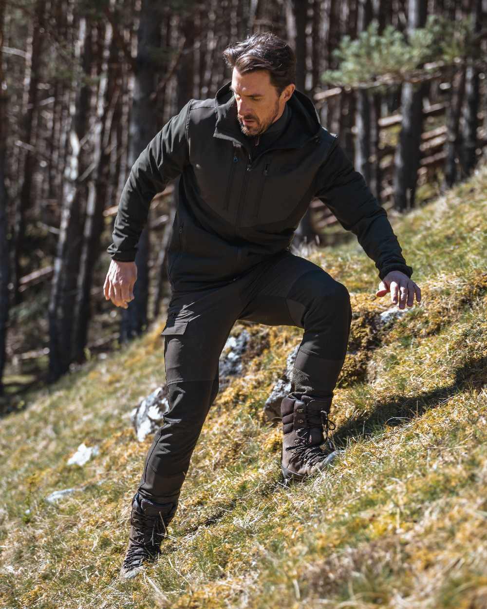 Green Coloured Hoggs of Fife Mens Ardross 4 Way Active Trousers on mountain background 