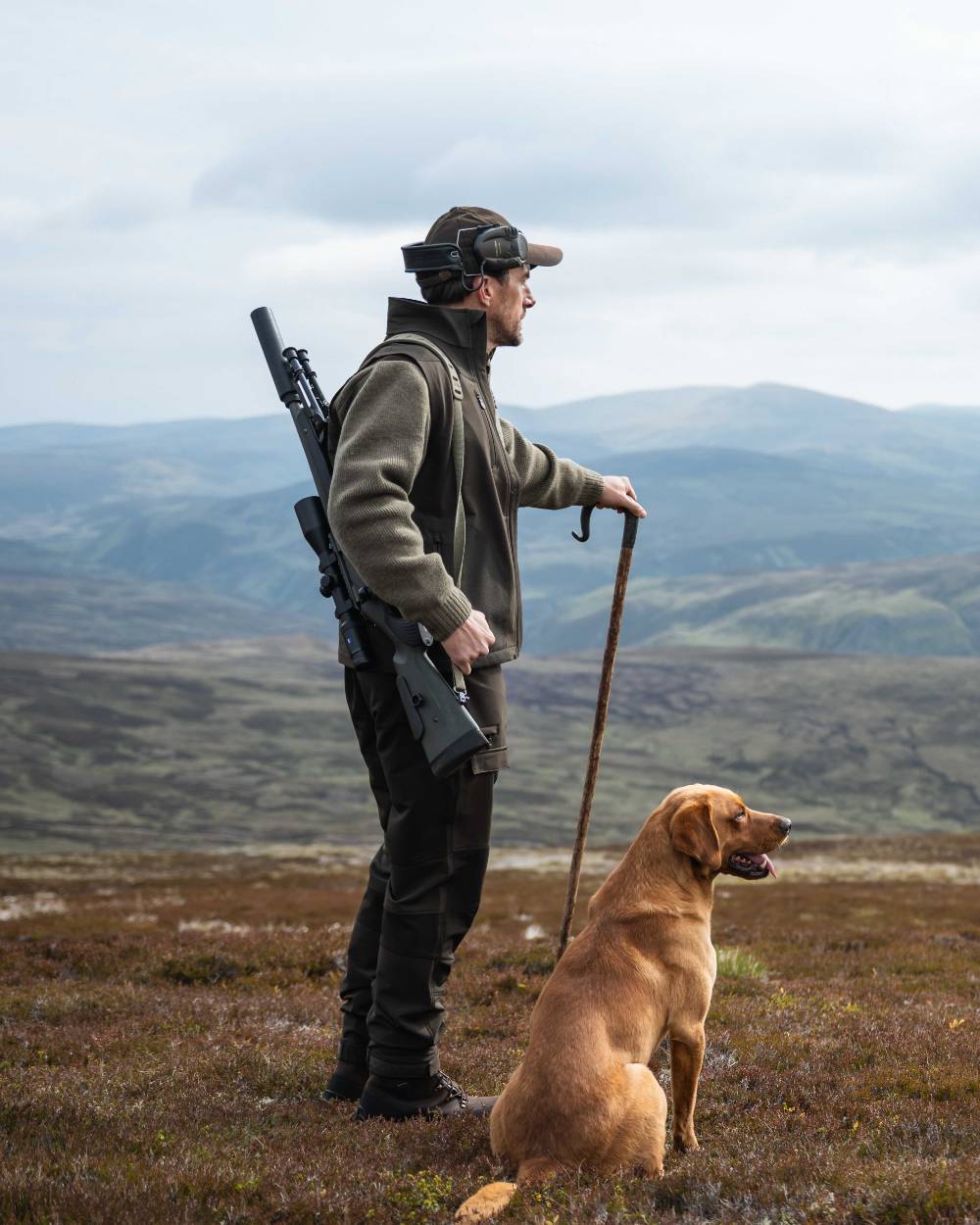 Green Coloured Hoggs of Fife Mens Ardross 4 Way Active Trousers on mountain background 