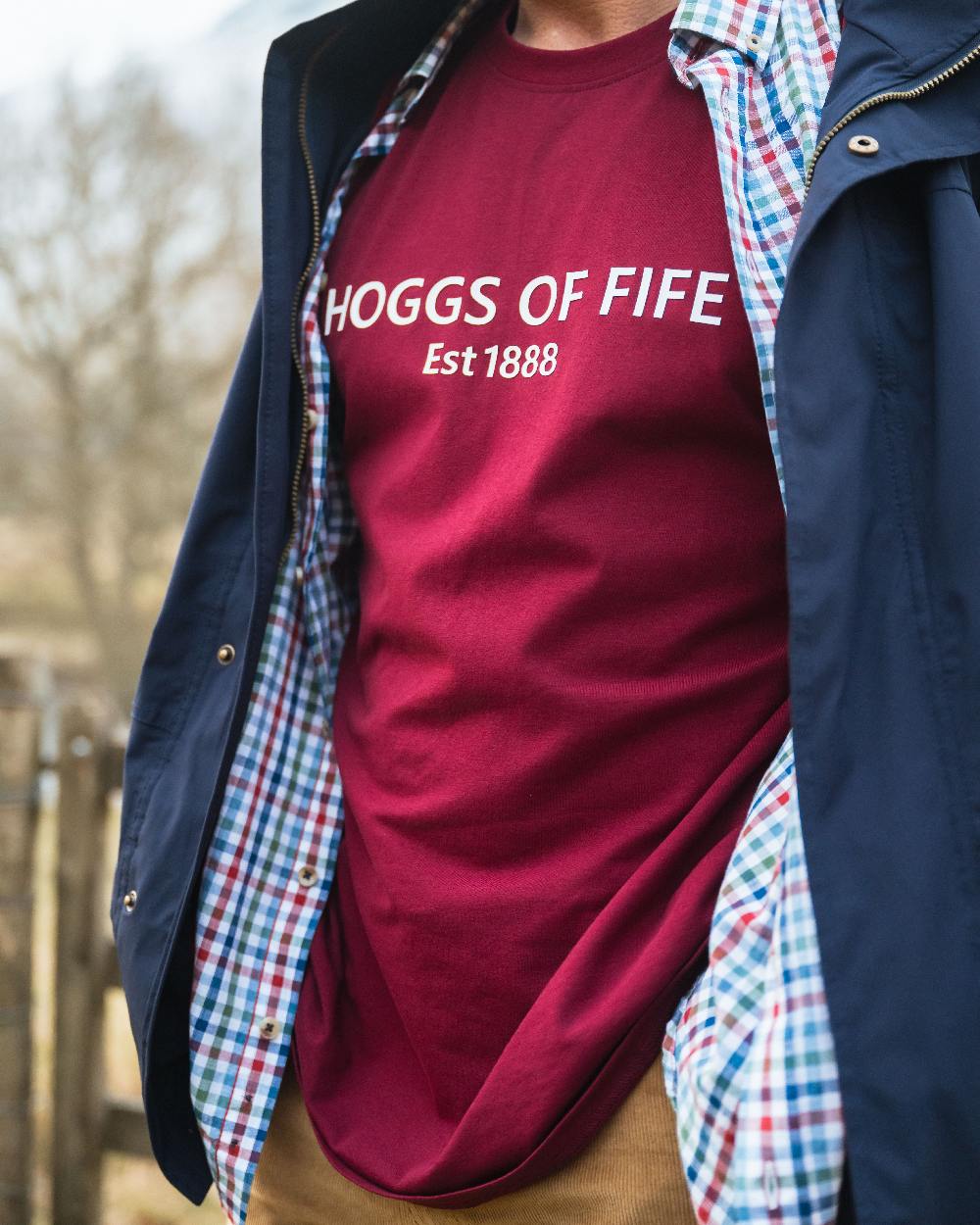 Burgundy Coloured Hoggs of Fife Mens Canonbie Printed T-Shirt on blurry background 