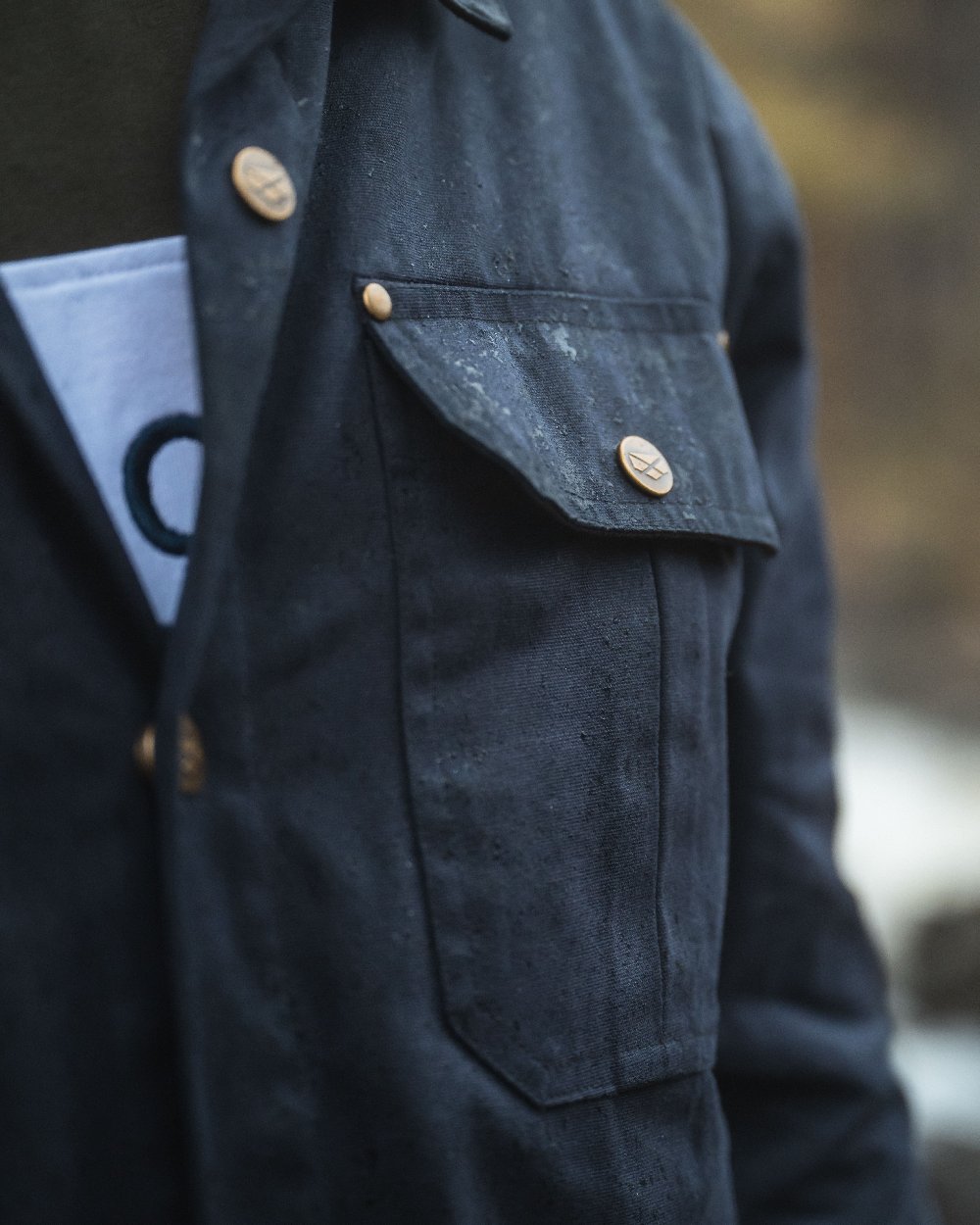 Midnight Navy Coloured Hoggs of Fife Mens Huntly Waxed Canvas Utility Overshirt on blurry background 
