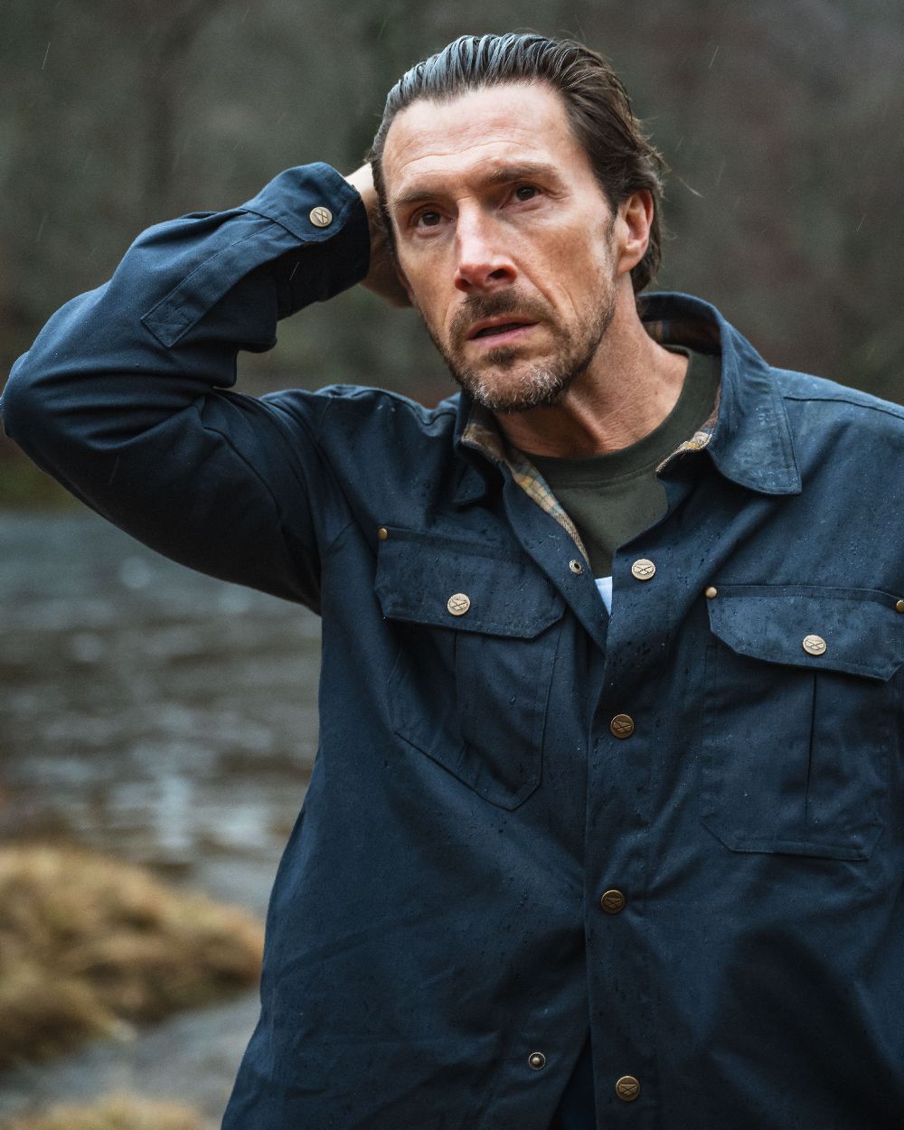 Midnight Navy Coloured Hoggs of Fife Mens Huntly Waxed Canvas Utility Overshirt on blurry background 