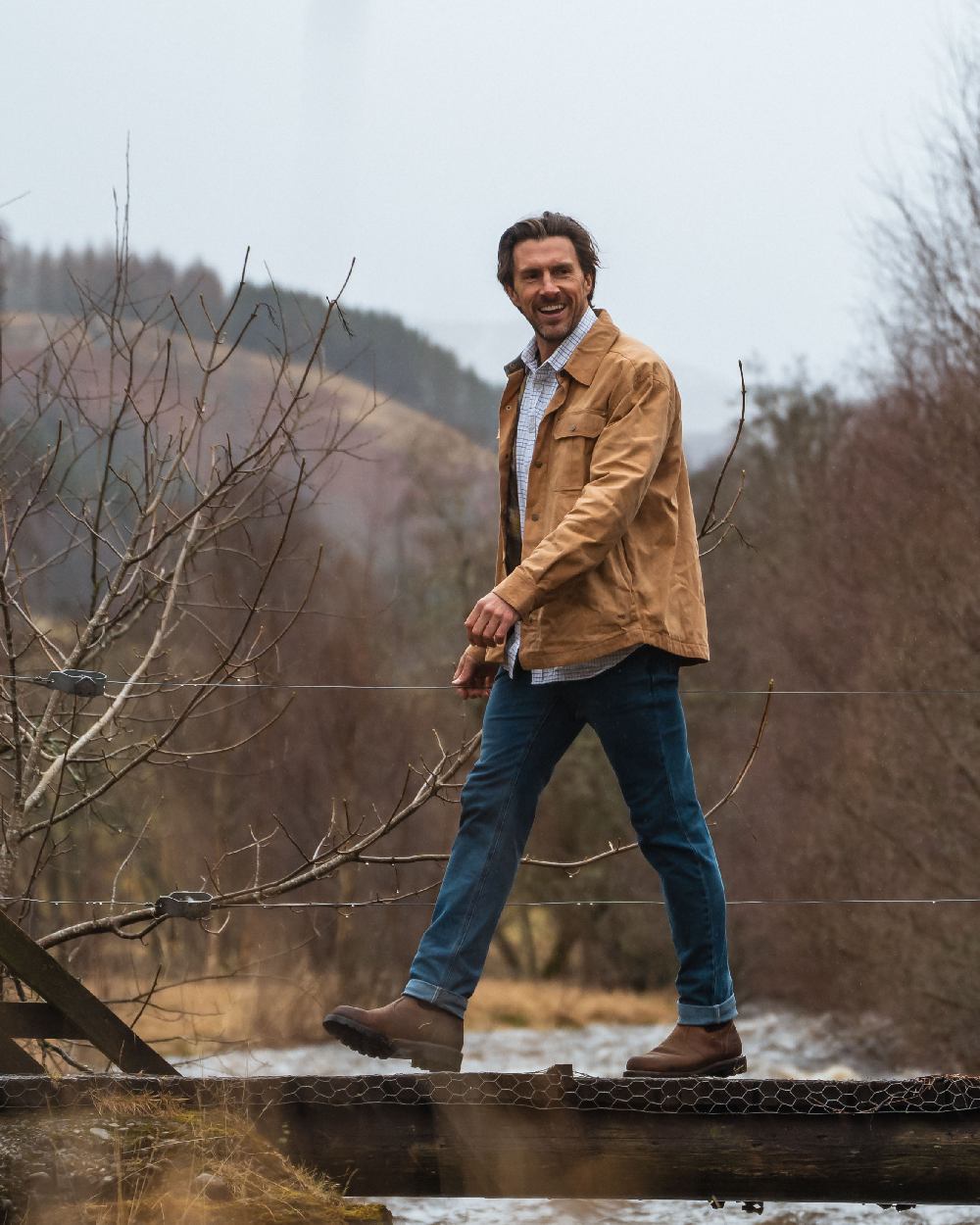 Tan Coloured Hoggs of Fife Mens Huntly Waxed Canvas Utility Overshirt on mountain background 