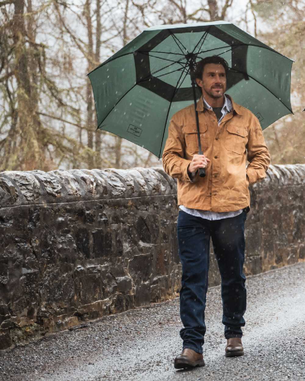 Tan Coloured Hoggs of Fife Mens Huntly Waxed Canvas Utility Overshirt on forest background 