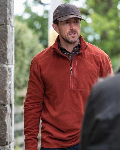 Burnt Henna Coloured Hoggs of Fife Mens Islander Techpro Quarter Zip Shirt on outdoor background 
