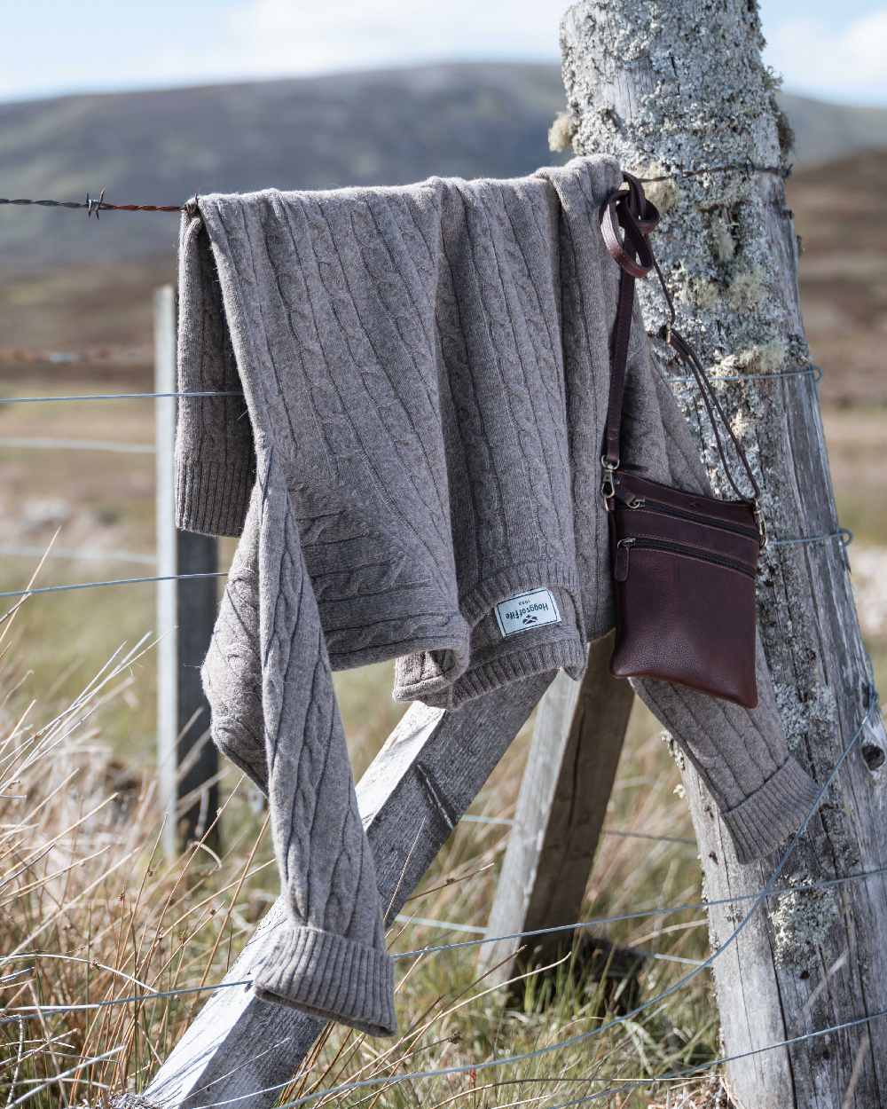 Oatmeal Marl Coloured Hoggs of Fife Mens Jedburgh II Cable Pullover on outdoor background 