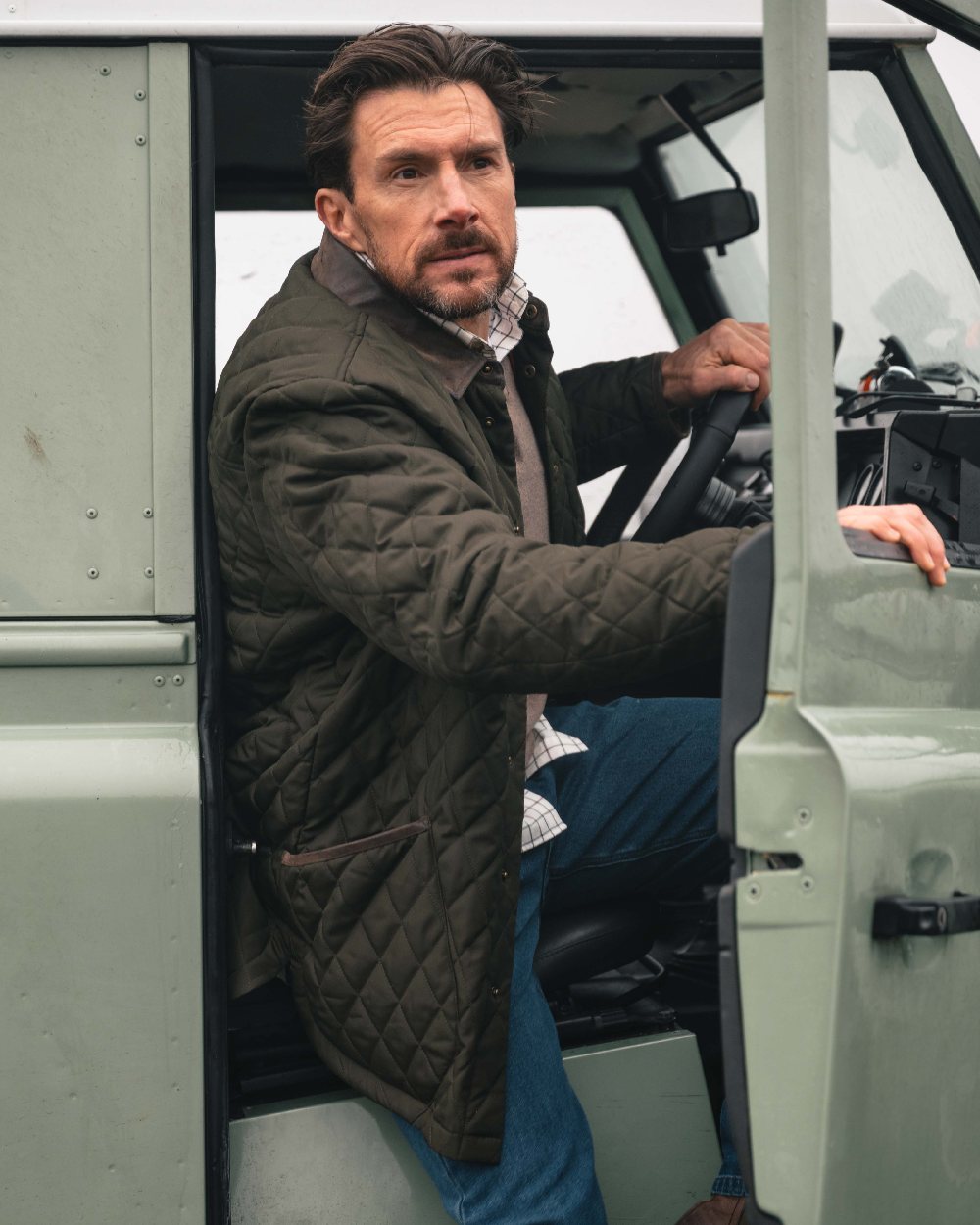 Forest Green Coloured Hoggs of Fife Mens Lochore Quilted Jacket on outdoor background 