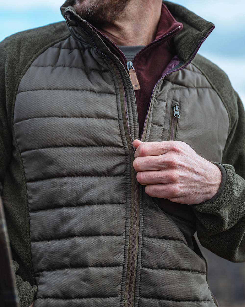 Juniper Marl Coloured Hoggs of Fife Mens Melville Hybrid Jacket on sky background 