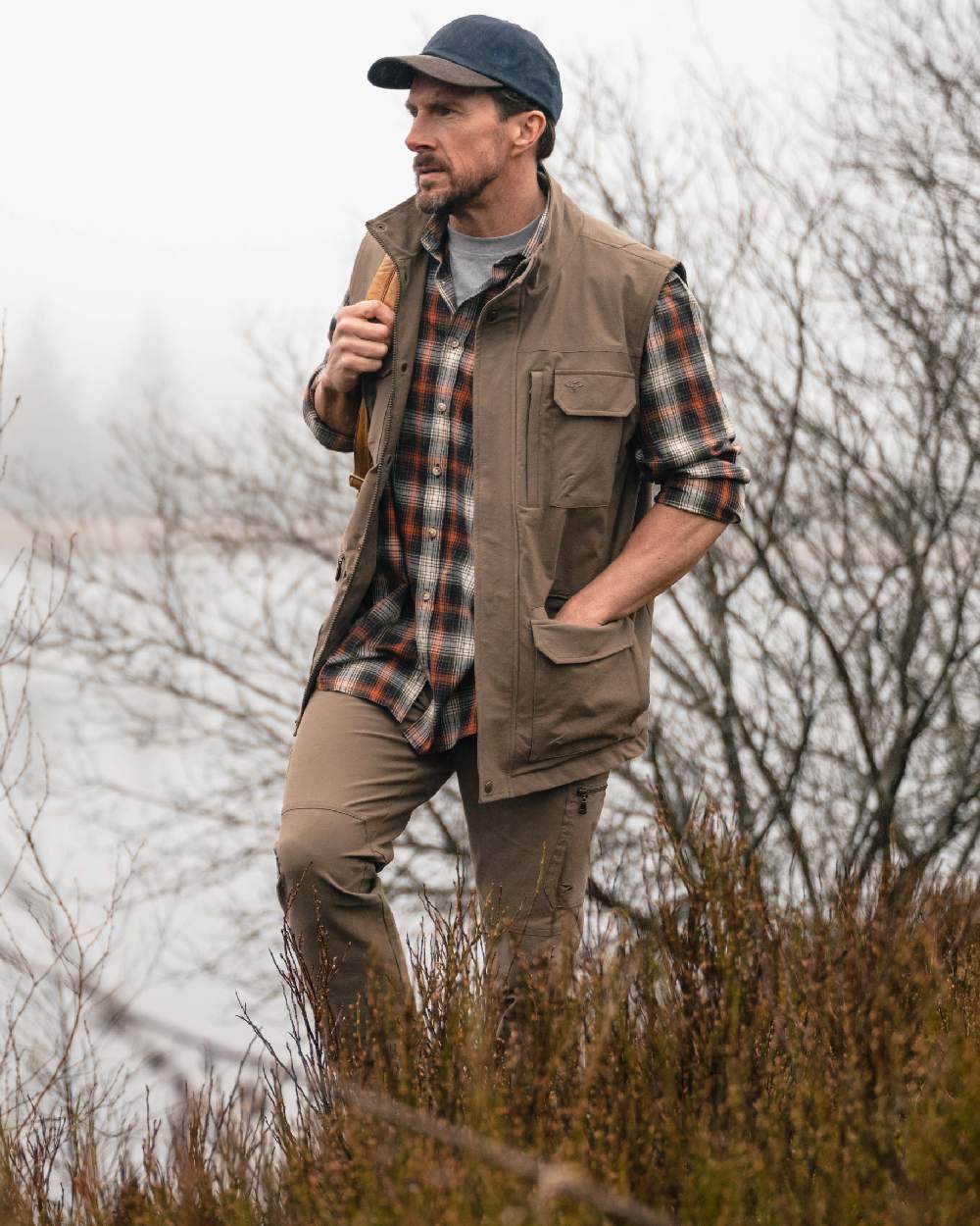 Khaki Coloured Hoggs of Fife Mens Rothesay Utility Gilet on lake background 