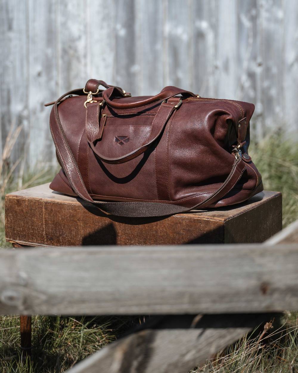 Conker Coloured Hoggs of Fife Monarch Leather Carryon Holdall on outdoor background 