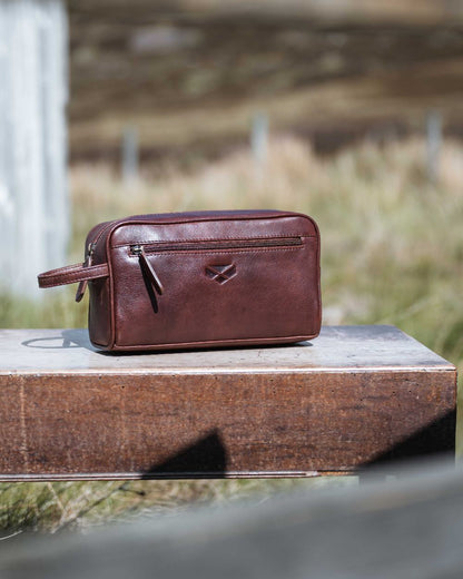 Conker Coloured Hoggs of Fife Monarch Leather Wash Bag on outdoor background 