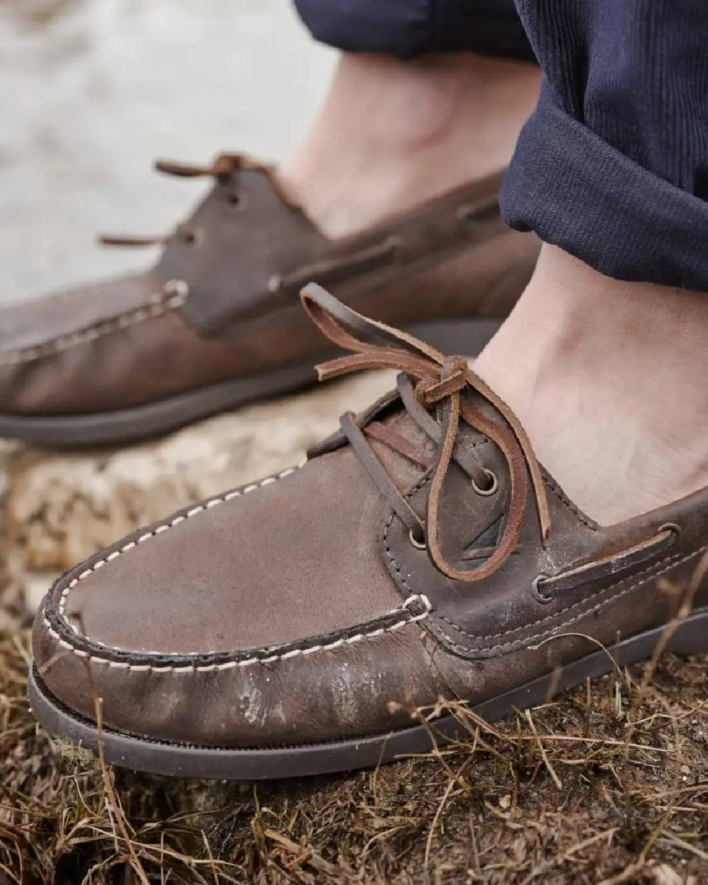 Waxy Brown Coloured Hoggs of Fife Mull Deck Shoes on ground background 