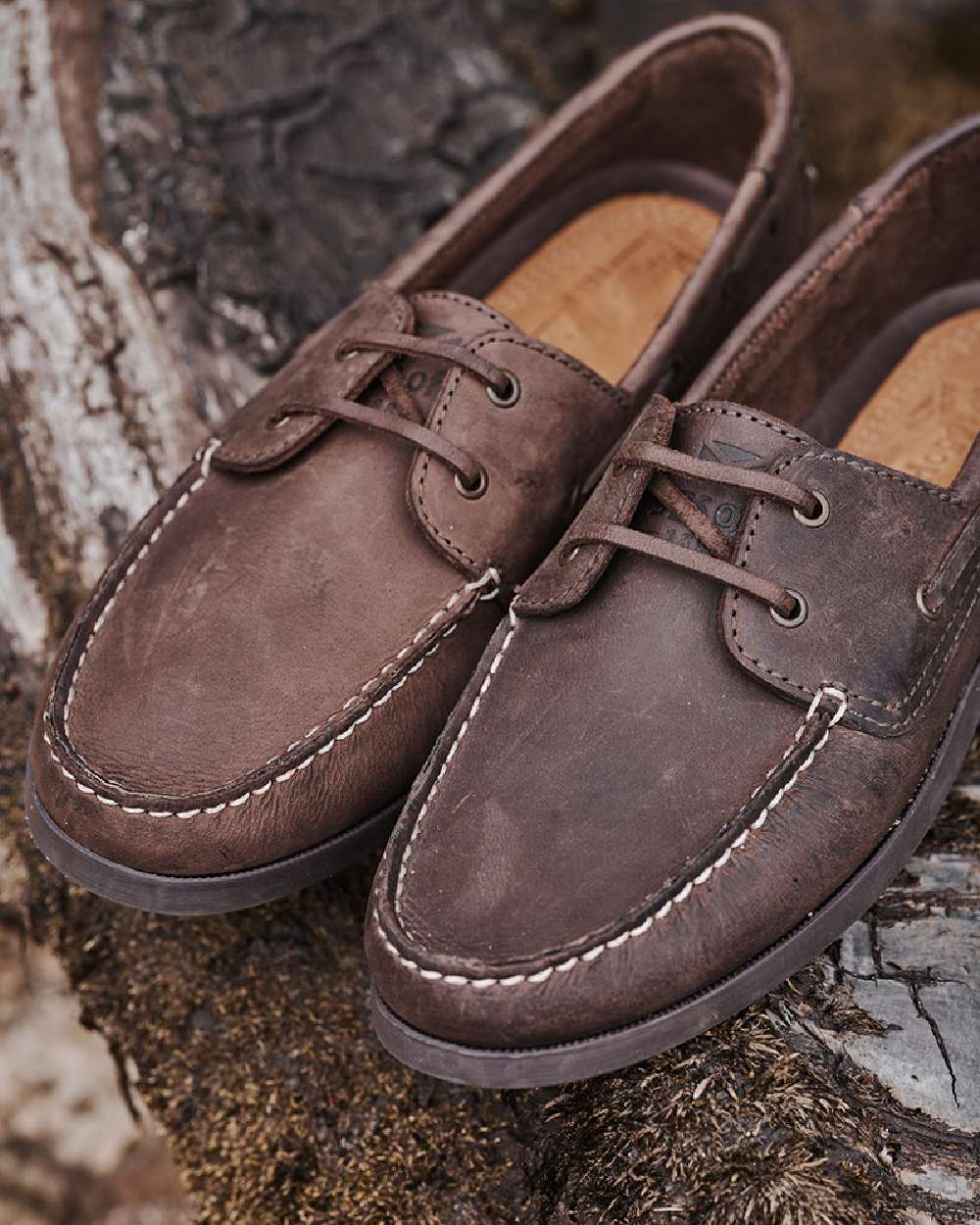 Waxy Brown Coloured Hoggs of Fife Mull Deck Shoes on ground background 