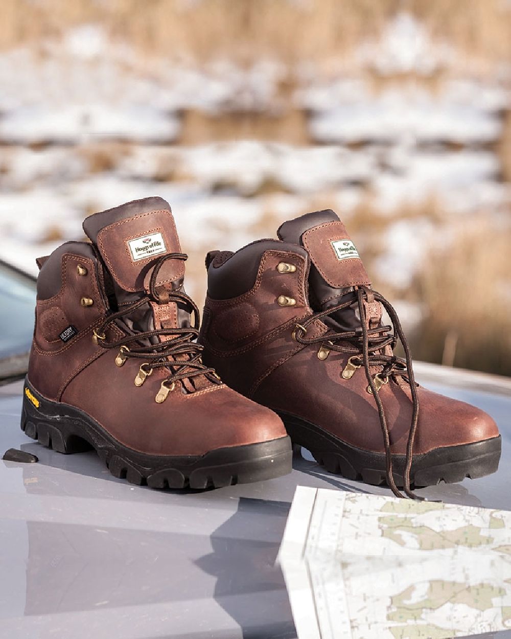 Brown Coloured Hoggs of Fife Munro Classic Leather Hiking Boots on car background 