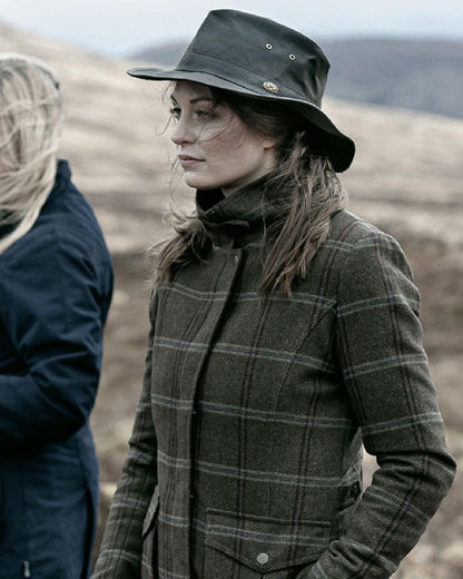 Bracken Tweed Coloured Hoggs of Fife Musselburgh Tweed Field Coat on blurry background 