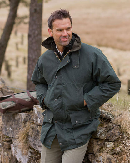 Olive Coloured Hoggs of Fife Padded Waxed Jacket on countryside background 