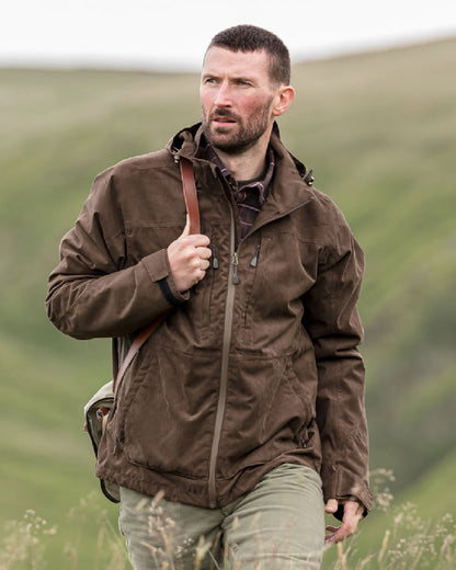 Brown Coloured Hoggs of Fife Rannoch Waterproof Shooting Jacket on blurry background 