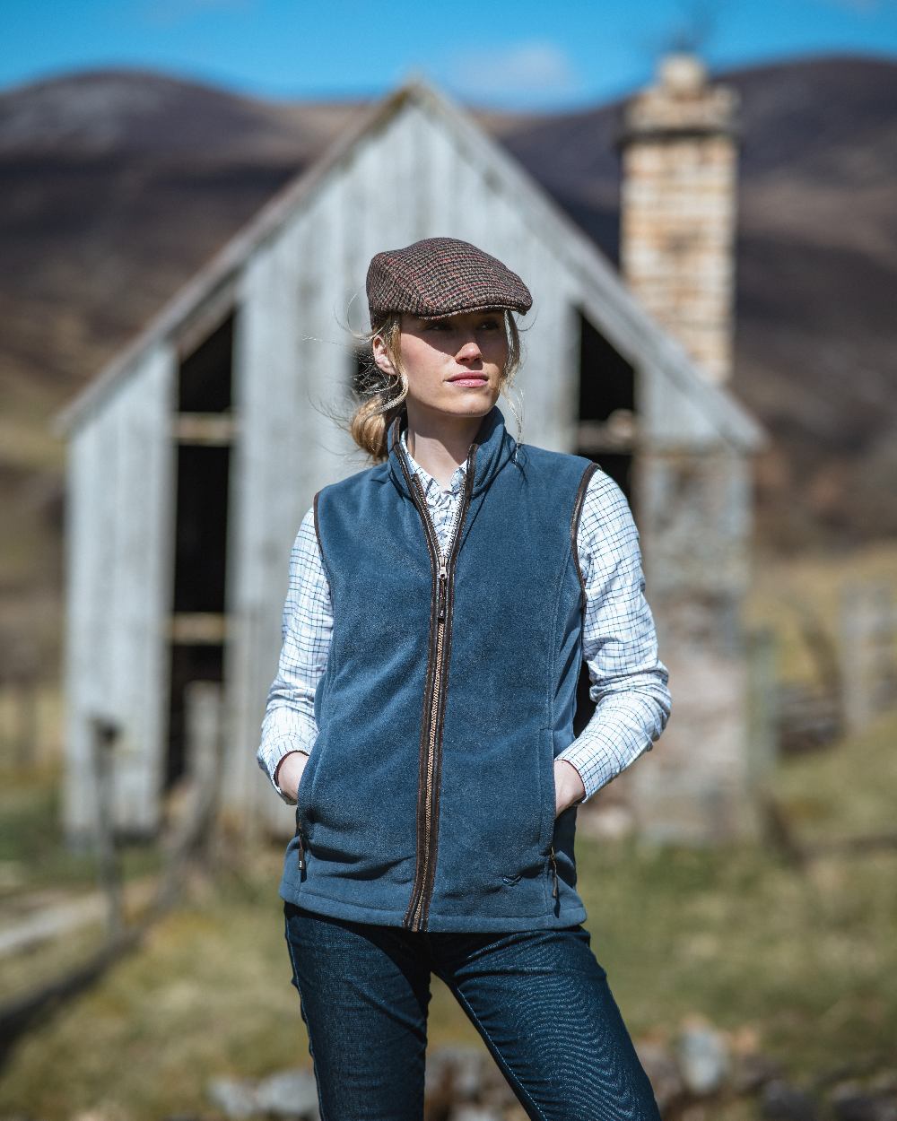 Slate Grey Coloured Hoggs of Fife Stenton Ladies Fleece Gilet on house background 