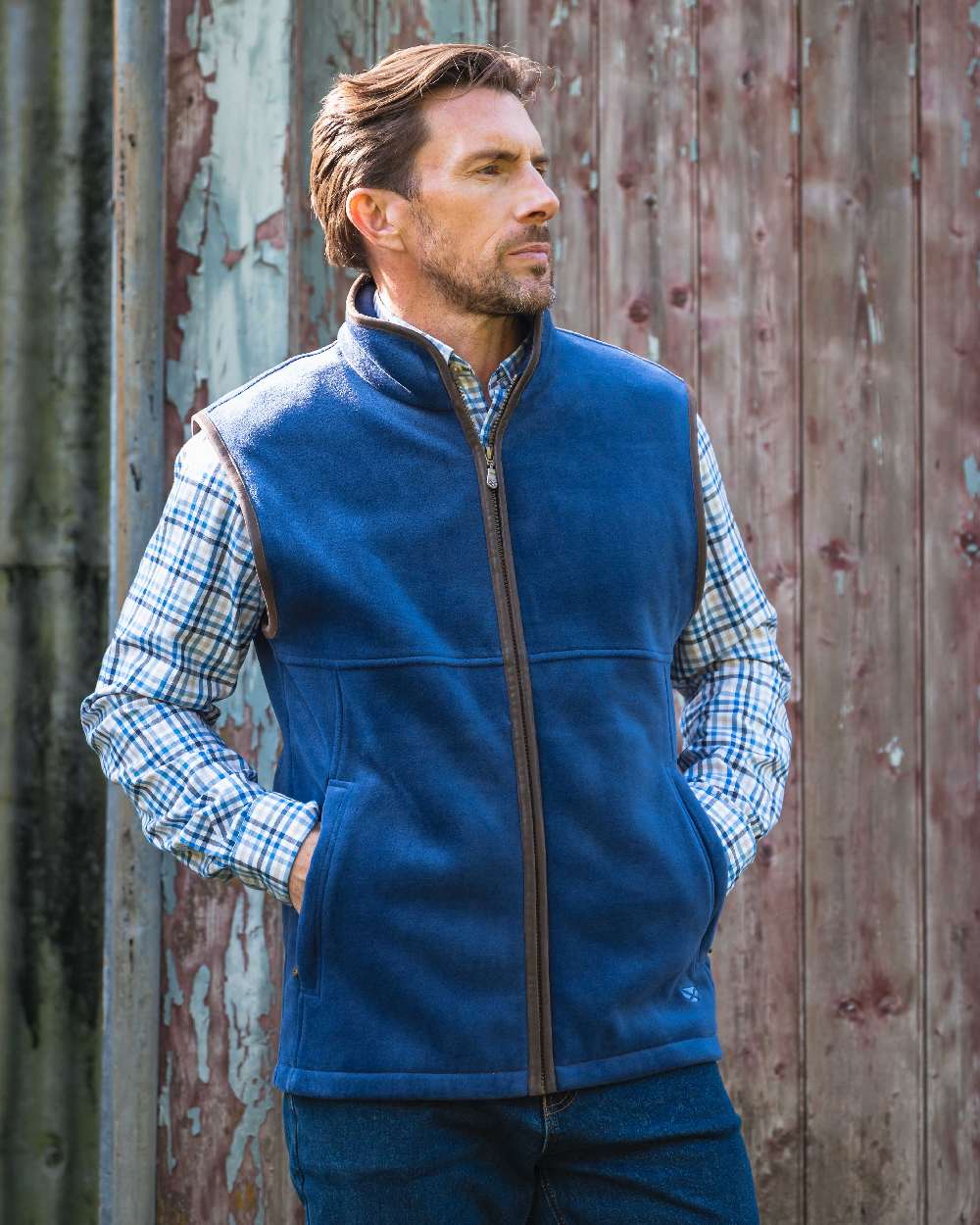 Nordic Blue coloured Hoggs of Fife Stenton Technical Fleece Gilet on forest background 