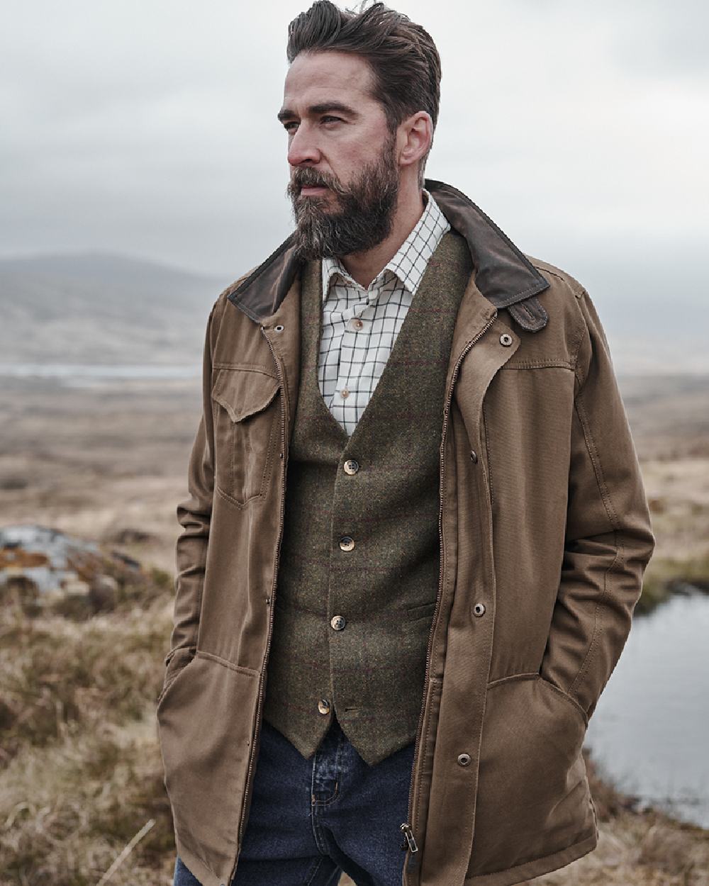 Camel Coloured Hoggs of Fife Stewarton Canvas Coat on countryside background 