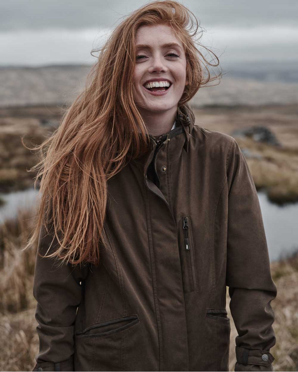 Sage Coloured Hoggs of Fife Struther Ladies Long Riding Coat on pond background 