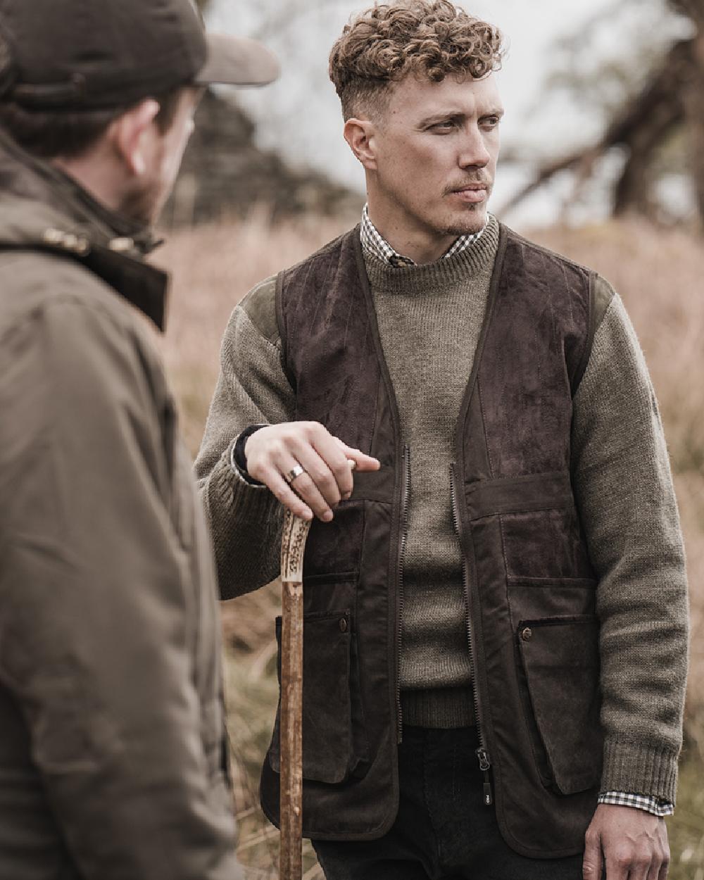 Dark Green coloured Hoggs of Fife Struther Shooting Vest on forest background 