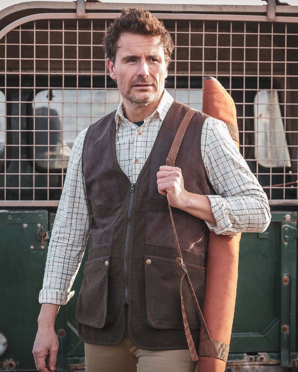 Dark Green coloured Hoggs of Fife Struther Shooting Vest on jeep background 